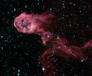 Infrared image taken by NASA’s Spitzer Space Telescope, revealing the glowing stellar nursery embedded within the Elephant's Trunk Nebula (IC 1396 A)